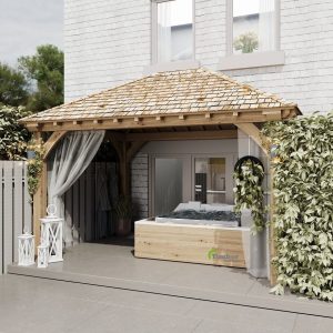 Oak gazebo with hot tub, offering a peaceful outdoor spa experience in a rustic setting