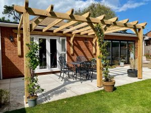Oak lean-to pergola 5m x 3.5m attached to a house, providing shaded outdoor space