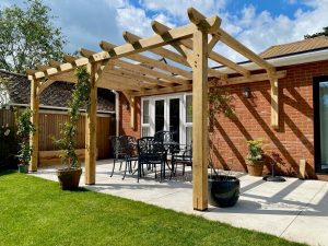 5m x 3.5m oak lean-to pergola enhancing a garden with stylish and functional design
