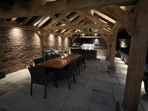 Three-bay oak gazebo with a hipped roof in a spacious garden