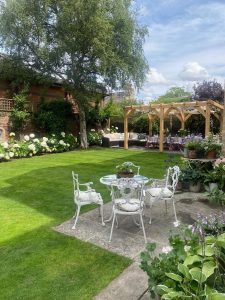 Stylish oak pergola with a transparent roof in a backyard