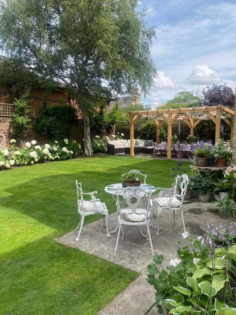 Stylish oak pergola with a transparent roof in a backyard