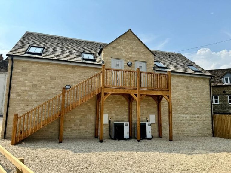 Outdoor oak staircase with a large landing in a garden setting