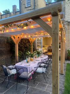 Elegant oak pergola with a transparent roof in a garden setting