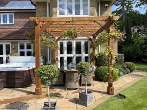 Intricate lattice design on an oak pergola, providing both shade and plant support.