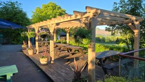 Three-bay oak pergola measuring 3 x 9 m, offering a spacious and elegant outdoor structure for gatherings.