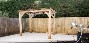 Oak pergola with roof offering protection from the elements while maintaining an open feel.