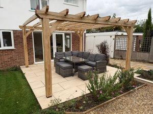 Solid oak garden pergola creating a stylish outdoor seating area