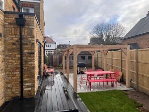 Modern oak pergola with clean lines, creating a stylish outdoor seating area