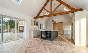 A traditional oak king post truss supporting a vaulted ceiling with strong mortise and tenon joints.