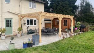 Handcrafted oak pergola with integrated lattice, providing a natural extension of the home’s outdoor space.