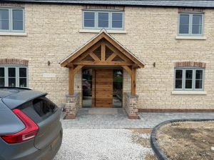 Oak porch with two front legs, adding a rustic and durable touch to a home's entrance