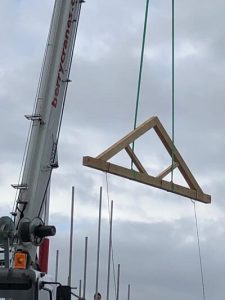 Structural oak queen post trusses featuring two vertical queen posts supporting the roof beams in a spacious interior