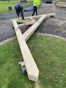 Oak raised tie shaped king post truss showcasing intricate craftsmanship and structural design