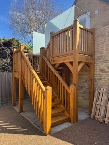Elegant U shape staircase crafted from solid oak for a grand interior.