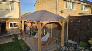 English oak frame and traditional hipped roof of a garden gazebo