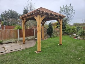 A classic 3 x 3 m oak gazebo, ideal for creating a cozy outdoor seating area with natural wood charm.