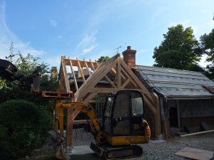 Oak framed gazebo with a lean-to roof, designed to blend seamlessly with the surrounding landscape.