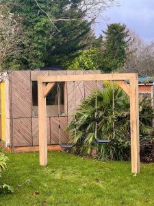 Bespoke oak swing frame crafted for comfort and durability.