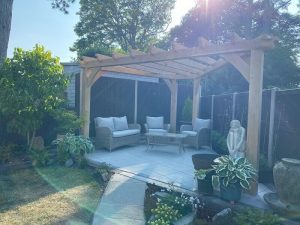 Triangle oak pergola designed to fit an angled garden boundary