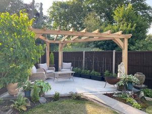 Triangle oak pergola fitted into a compact garden corner