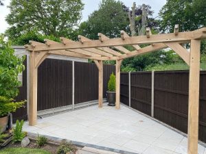 Triangle oak pergola creating a modern outdoor seating area